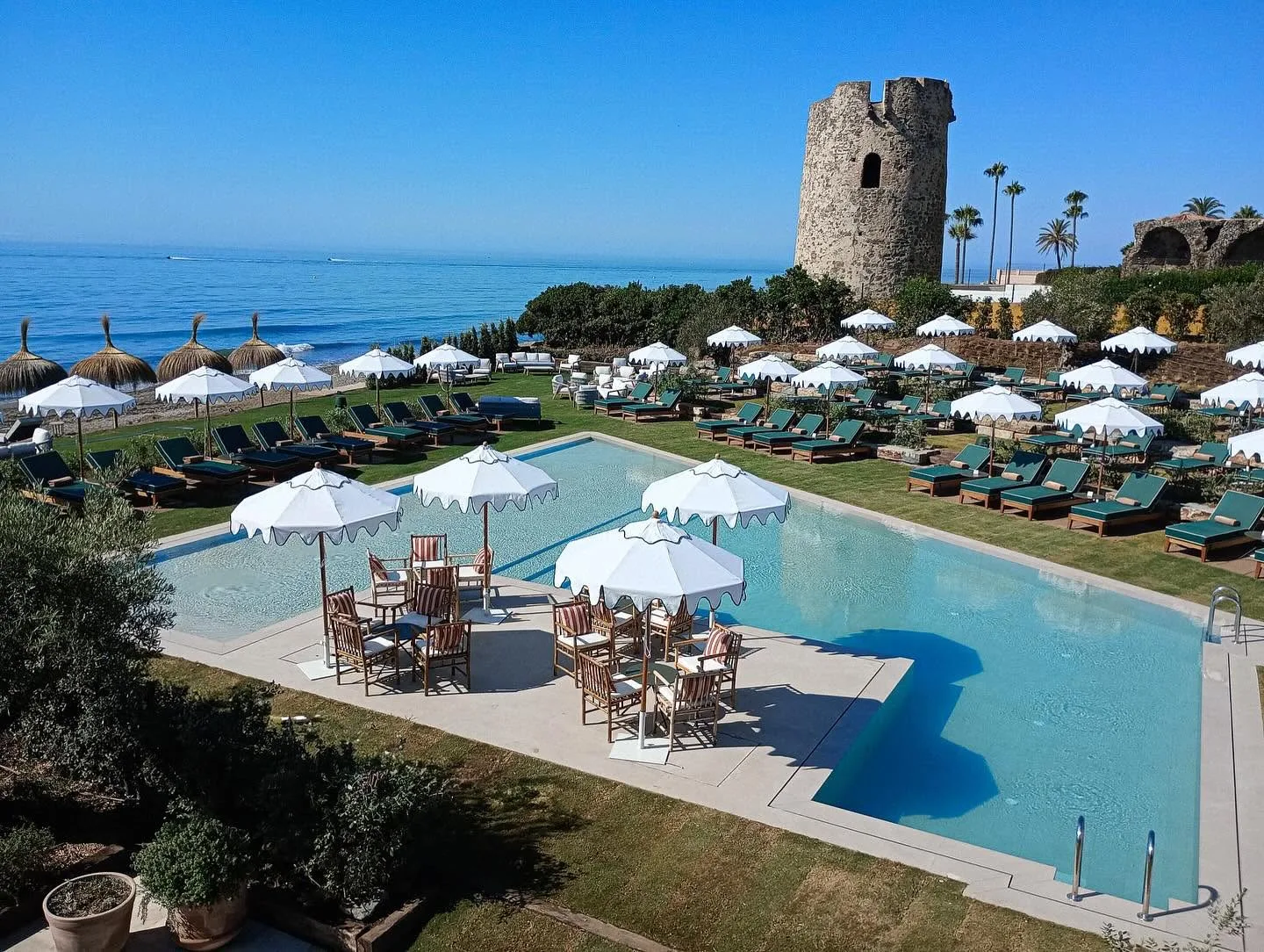 Poolside umbrellas with the watchtower behind