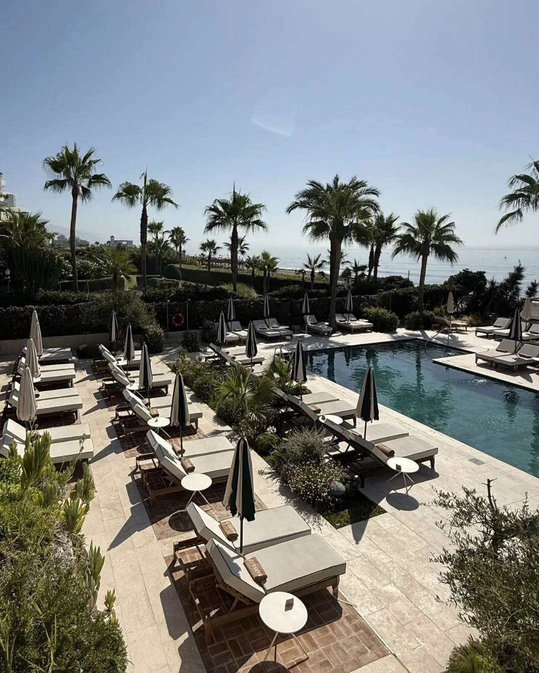 Sunbeds by the pool with sea views
