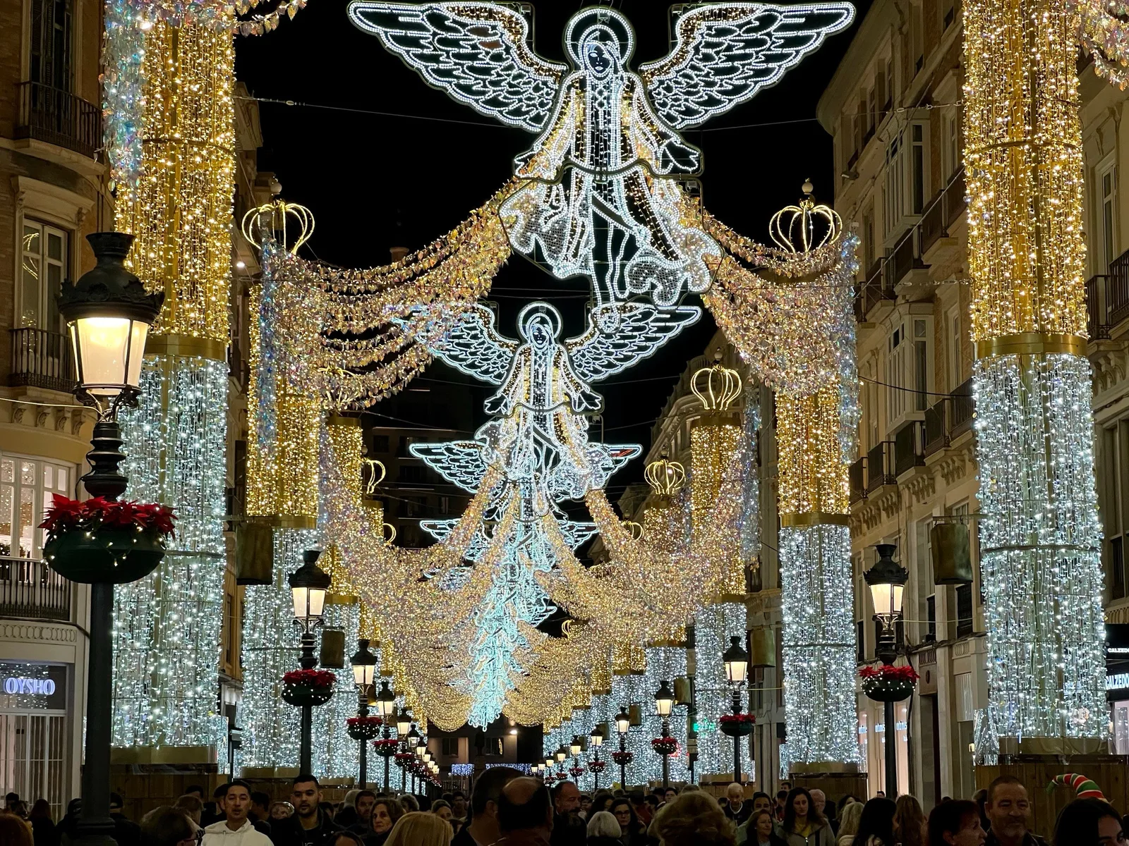 The Calle Larios Christmas lights — angels over the crowd