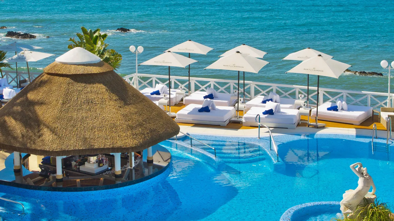 The Polynesian pool and swim-up bar over the sea at El Oceano